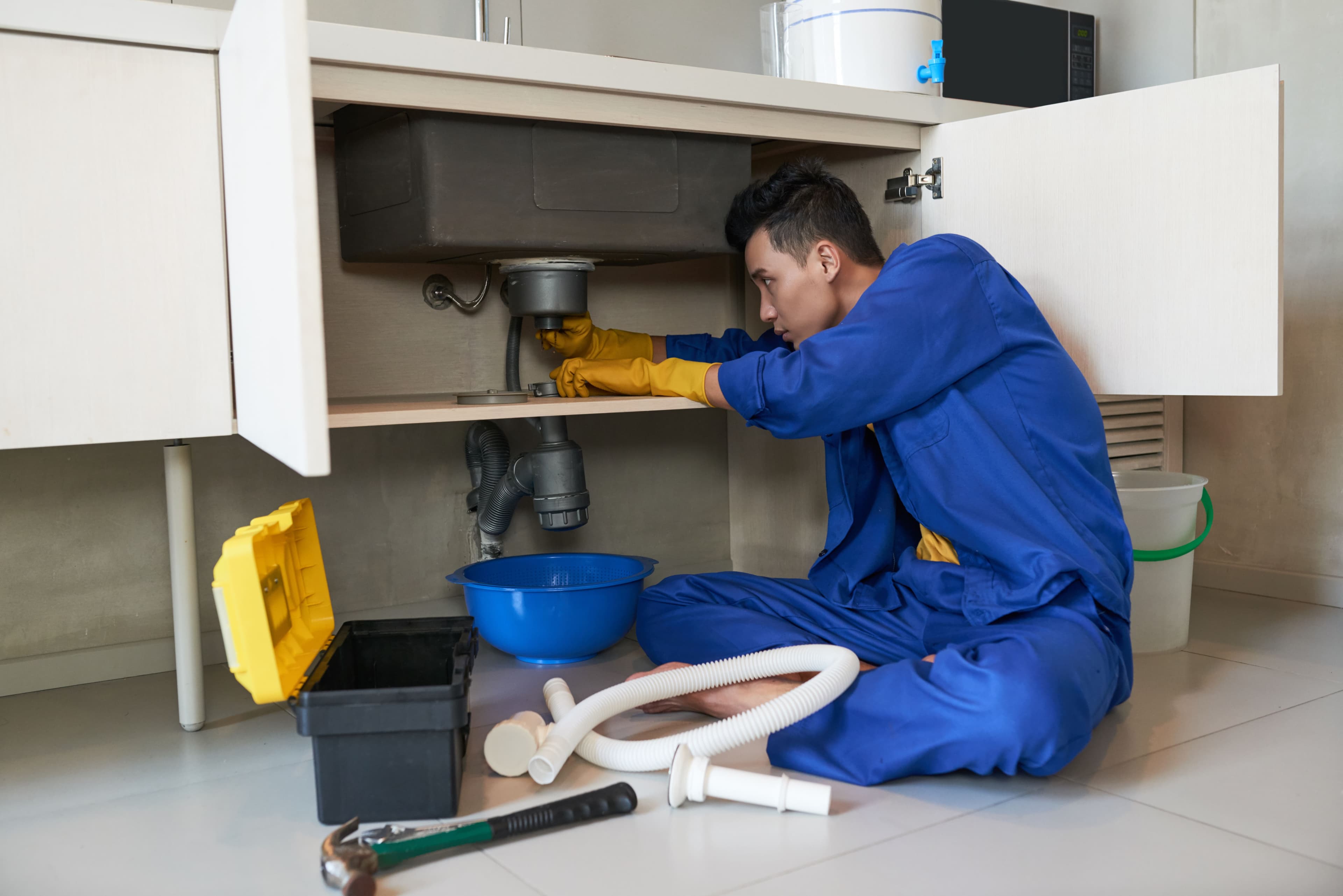 Plumber under sink