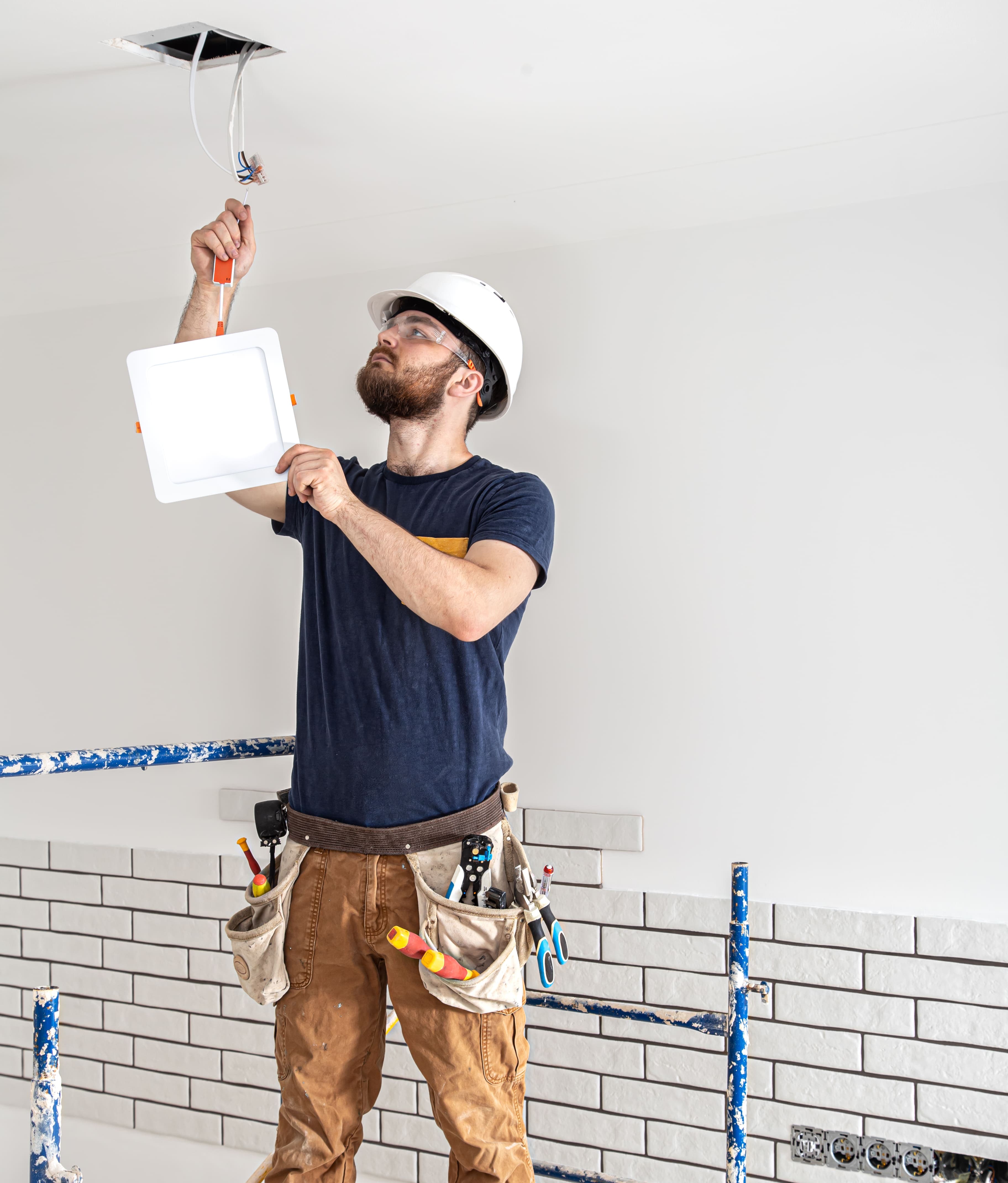Handyman working on wall installation